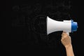 hand holding megaphone over chalkboard background. Royalty Free Stock Photo