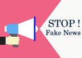 Hand holding megaphone with text Stop fake news Royalty Free Stock Photo