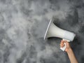 Hand Holding Megaphone on Textured Background Royalty Free Stock Photo