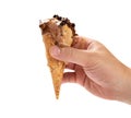 Hand holding melting coffee flavor ice cream cone with chocolate on white background with clipping path Royalty Free Stock Photo