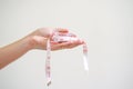 Hand holding a mesuring tape Royalty Free Stock Photo
