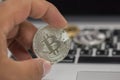 Hand holding metal bitcoin