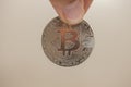 Hand holding metal bitcoin