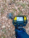 Hand holding metla detector in the forest Royalty Free Stock Photo