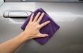 Hand holding microfiber cloth polishing gray car Royalty Free Stock Photo