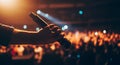 Hand Holding Microphone at Concert Under Bright Stage Lights Royalty Free Stock Photo