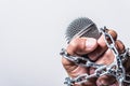 Hand holding microphone and have chain on fist hand Royalty Free Stock Photo