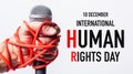 Hand holding microphone and have roped on fist hand with 10 december international HUMAN RIGHTS DAY text Royalty Free Stock Photo