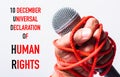 Hand holding microphone and have roped on fist hand with 10 december universal declaration of HUMAN RIGHTS text Royalty Free Stock Photo