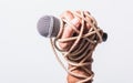 Hand holding microphone and have roped on fist hand Royalty Free Stock Photo