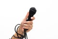 Hand holding a microphone isolated on white background