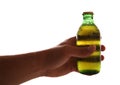 Hand holding a mini bottle of larger Royalty Free Stock Photo