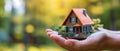 Hand Holding Miniature House Model, Symbolizing Property Insurance And Home Ownership