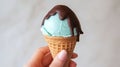 a hand holding an Mint Choco ice cream cone - ai. Royalty Free Stock Photo