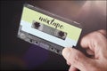 Hand holding mixtape audio cassette