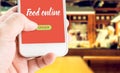 Hand holding mobile with Order food online with blur restaurant Royalty Free Stock Photo