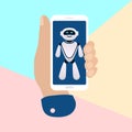 hand holding mobile phone with artificial chat robot bot on pastel colored blue and pink background