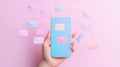 hand holding mobile phone with colorful envelopes floating around it, creating playful vibe