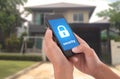 Hand holding mobile phone with concept technology home security Royalty Free Stock Photo