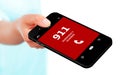 Hand holding mobile phone with emergency number 911 Royalty Free Stock Photo