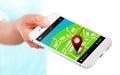Hand holding mobile phone with gps application and map over whit Royalty Free Stock Photo