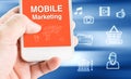 Hand holding mobile phone with MOBILE MARKETING word with relate