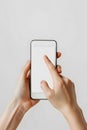 Hand Holding Mobile Phone with Screen Mockup Showing Scrolling Display Isolated on White Background Royalty Free Stock Photo