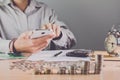 Businessman hand holding mobile phone on the table with a medal recognizing computation and. Sunset light Business Background