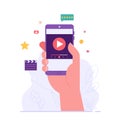 Hand holding mobile phone using and watching streaming service with clapper. Streaming cinema concept. Concept of video marketing Royalty Free Stock Photo