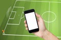 Hand holding mobile phone, view live soccer euro game on mobile