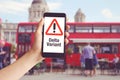 Hand Holding Mobile Phone With With Warning Message Delta Variant And Red Bus