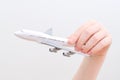 Hand holding model airplane. Royalty Free Stock Photo