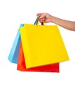 Hand holding multicolored paper bags isolated on white Royalty Free Stock Photo