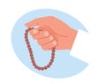 Hand holding Muslim wooden Holy rosary or buddhist mala, praying people. Islam religion symbol. Religion sign. Prayer