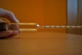 Hand holding new densimeter hydrometer used for brewing beer at home