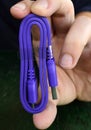 Hand holding new usb 3 purple cable Royalty Free Stock Photo