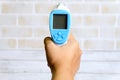 Hand holding non contact infrared thermometer for measure a body temperature. Healthcare and medical theme