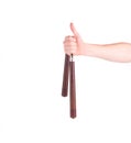 Hand holding nunchaku weapon.