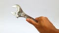 Hand holding old adjustable wrench isolated over white Royalty Free Stock Photo