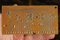 hand holding an old brown microcircuit