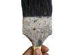 A hand holding old dirty paint brush Royalty Free Stock Photo