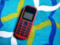 Old Mobile Phone with Texting or SMS Button Keyboard or Keypad on Colorful Carpet Background Royalty Free Stock Photo