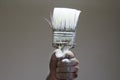 Hand holding an old paint brush Royalty Free Stock Photo