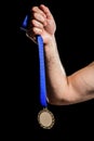 Hand holding olympic gold medal Royalty Free Stock Photo