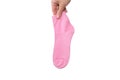 A hand holding one pink cotton organic sock isolated on white Royalty Free Stock Photo