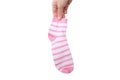 A hand holding one pink and white striped cotton organic sock isolated on white Royalty Free Stock Photo