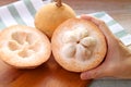 Hand Holding an Opened Fresh Ripe Santol Fruit or Wild Mangosteen