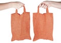 Hand holding orange fabric reusable shopping bag Royalty Free Stock Photo