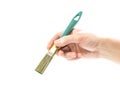 Hand holding a paint brush. Close up. Isolated on a white background Royalty Free Stock Photo