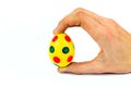 Hand holding painted yellow easter egg with dots Royalty Free Stock Photo